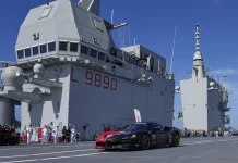 One man in an Italian supercar atop an aircraft carrier has a record in his sights 1